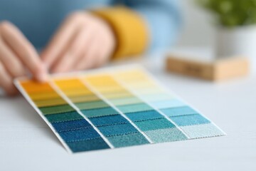 Poster - close-up of hands selecting eco-friendly fabric swatches in bright design studio