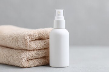 Poster - white spa spritz bottle with minimal design against backdrop of fluffy towels