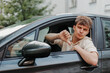© glebcallfives - Sad young driver showing thumbs down in car. Bad customer service by repair shop