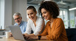 © Sulfabndi - Happy diverse business team collaborates on a project using a laptop, achieving success together in a modern office environment.