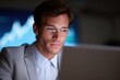 © Firadoaw - Businessman focused on laptop with financial charts in background