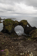 Wall Mural - Cloudy view over Gatklettur rock formation, Iceland.