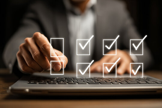 Man selects options from digital checklist on a laptop. Represents agreement, choice, compliance, or task completion. Use for business, marketing, or web design.