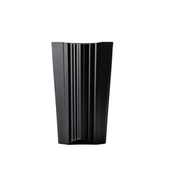 Poster - Monochrome still life presents a modern, fluted vase set against a stark black backdrop in studio
