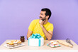 © luismolinero - Man in a table with a big cake looking to the side