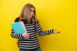 © luismolinero - Young student woman isolated on yellow background background with surprise expression while looking side