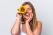 © luismolinero - Young caucasian woman isolated on white background holding a sunflower while smiling. Close up portrait
