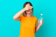 © luismolinero - Young Romanian woman with a bottle of water isolated on blue background covering eyes by hands. Do not want to see something