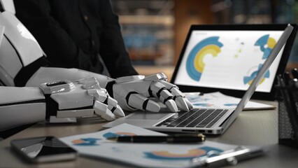 Poster - A robotic hand interacts with a laptop, symbolizing the future of technology and artificial intelligence in a contemporary workspace filled with digital documents.Noogenesis