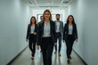 © MOBASHIR-RAHMAN - A Diverse Team of Professionals Walking in a Bright Office Corridor, Modern Business Team Approaching in a Well-Lit Hallway