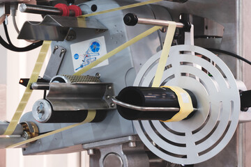 Aufkleber - Fragment of the conveyor of sticking labeling machine. Abstract industrial background.