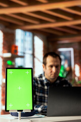 Poster - Focus on employee in blurry background using green screen tablet, preparing presentation. Close up of mockup device used by remote worker finishing business project, uploading files
