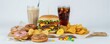 © Pete - Assortment of unhealthy food includes double cheeseburger, french fries, donuts, soda drinks, candy. High carbohydrate, sugar, fat content makes items detrimental to health. Obesity, diabetes, poor