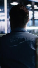 Fototapete - Vertical video Server room software developer using AI to review infrastructure diagnostics. IT employee in data center analyzing performance data using artificial intelligence technology on devices