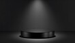 © Sojib_Islam - Black circular podium illuminated by a single spotlight on a dark gray background