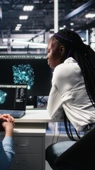 Fototapete - Vertical video Server room computer scientists using AI to review infrastructure diagnostics. IT specialists working together in data center, analyzing performance data using artificial intelligence
