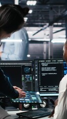 Poster - Vertical video Multiethnic team in diverse data center coding with generative AI assistance. Asian man oversees work by IT expert leveraging artificial intelligence large language model, camera A