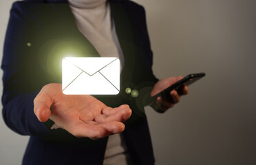 Poster - Businessperson holding a cell phone in one hand while holding a virtual icon of an email envelope in the other.