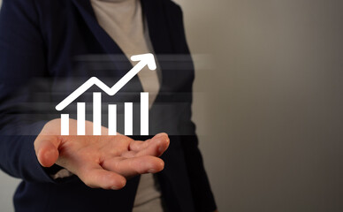 Poster - Businesswoman holding a virtual icon of a graph with an upward arrow.