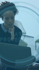Poster - two people discussing work over laptop with digital interface animation overlay