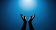 © Mohsin - Hands reaching up toward a bright light against a blue gradient background evoke themes of hope, faith, and spirituality, suitable for inspirational or religious content.