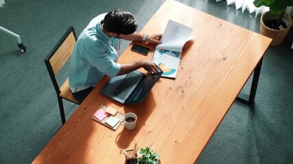 Poster - Top view of business man working on laptop while looking at financial chart. Manager with casual cloth sitting at meeting table while using computer analyze data while looking screen. Convocation.