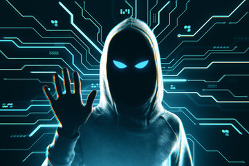Fototapete - Mysterious hooded hacker figure with glowing eyes and raised hand in front of digital circuit background symbolizing cybercrime threat concept.