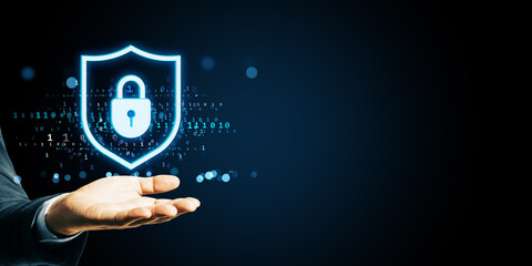 Poster - Hand holding glowing digital shield with padlock icon for cybersecurity and data protection on dark tech background for business concept.