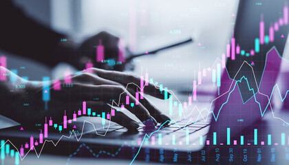 Poster - Hands typing on laptop keyboard with glowing stock market charts and financial graphs overlayed in digital interface concept on office desk background.