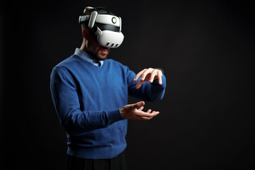 Poster - Person engages in virtual reality experience while wearing a VR headset in a dark studio environment