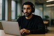 © Rawpixel.com - Focused man using laptop headphones.