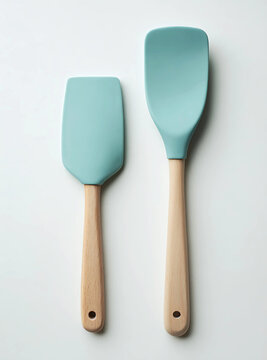 Two silicone spatulas with wooden handles are isolated on white background