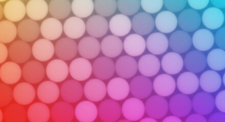 Colorful bokeh background with circular lights in a gradient pattern from red to blue