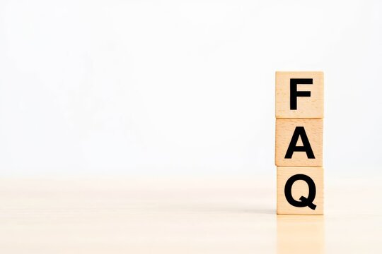 FAQ - text on wooden cubes, on wooden background.