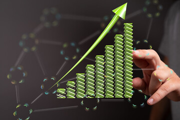 Poster - Stock photo of a hand interacting with a 3D green upward trending graph, symbolizing growth and success.