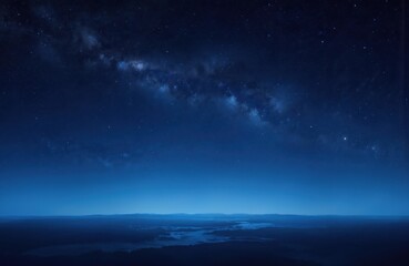 Wall Mural - Deep blue night sky countless twinkling stars, Milky Way galaxy over dark, hazy landscape. Cosmic scene evokes wonder, vastness of universe. Perfect for themes of space, astronomy, nighttime beauty.