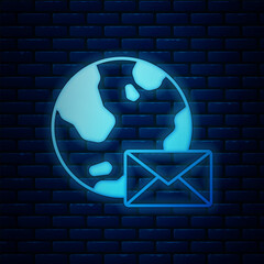 Poster - Glowing neon Earth globe with mail and e-mail icon isolated on brick wall background. Envelope symbol e-mail. Email message sign. Vector