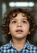 © Alis - Close-up portrait of a curious child looking upward.