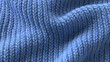 © SS Stock - Close-up of soft, blue knitted fabric, showcasing texture and pattern ideal for cozy clothing or home decor inspiration.