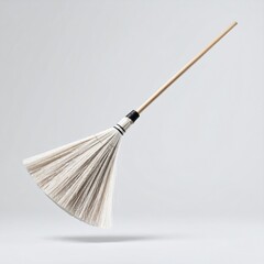 Poster - Floating Broom Isolated On Soft Grey Background With Sleek Ergonomic Handle And White Bristles