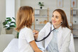 © Studio Romantic - Pediatrician checking kid patient in clinic, kind female doctor, nurse holding stethoscope examining little child during regular pediatric checkup in medicare hospital, children medical health care