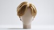 © JT Studio - A realistic blond wig styled on a faceless mannequin head against a plain white background.