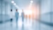 © Blurred Bokeh - Bright medical hallway with doctors and nurses walking, clinical lighting.
