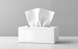 © guo - Ultra quality image of box of tissues mockup concept. A simple white tissue box with tissues partially pulled out, set against a neutral gray background. High quality