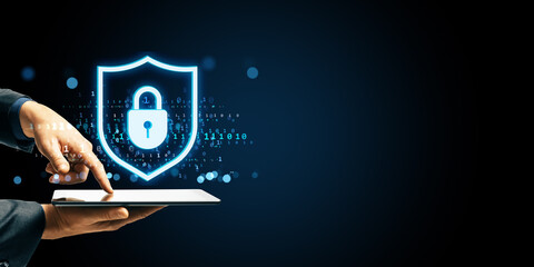 Fototapete - Cybersecurity concept with glowing padlock shield hologram over tablet screen showing data protection and privacy in digital business environment.