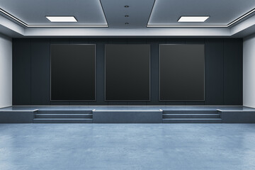 Poster - Modern exhibition room with three large black vertical poster frames on a dark wall in a clean indoor gallery interior setting. 3D Rendering