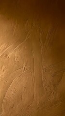 Poster - Textured wall with a warm, golden color, close-up of decorative stucco finish, and subtle light and shadow creating depth and visual interest