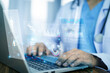 © Suriyo - Doctor typing on laptop with virtual AI health interface, managing patient data securely and improving decision-making through automation