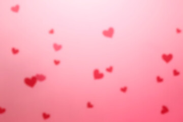 Poster - Blurry red heart shapes floating on a soft pink gradient background creating a romantic and loving atmosphere for Valentine's Day