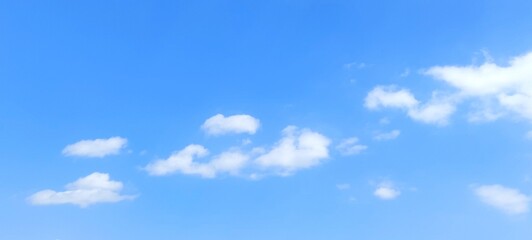 blue sky background with white clouds in summer. soft white clouds float in the clear blue sky. clea